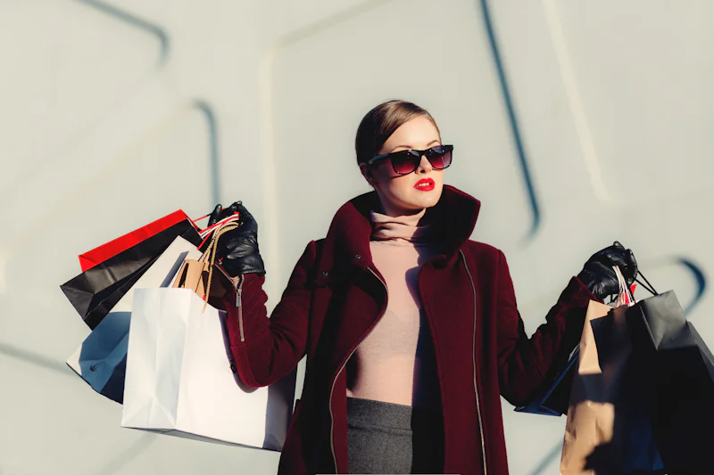 Shopper carrying paper shopping bags
