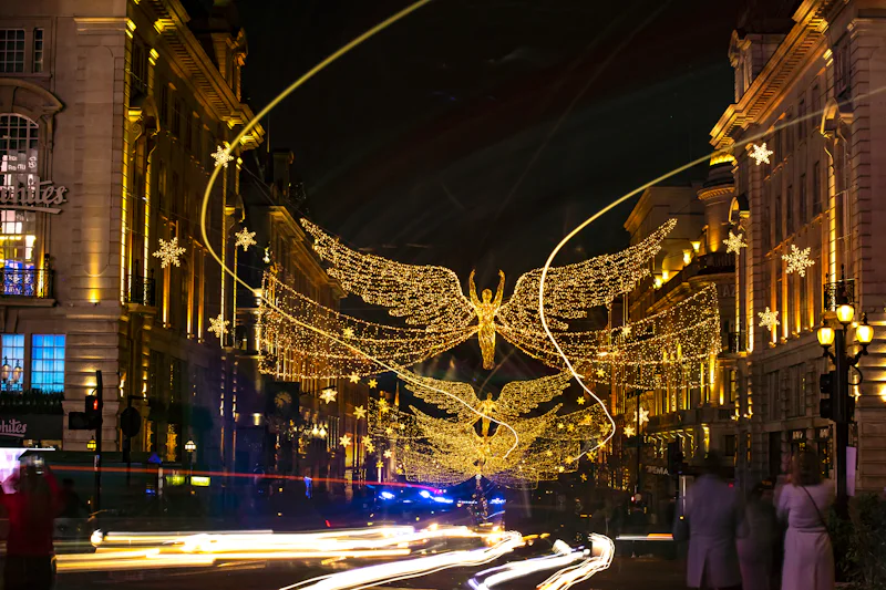 City shopping street at night decorated with Christmas lights