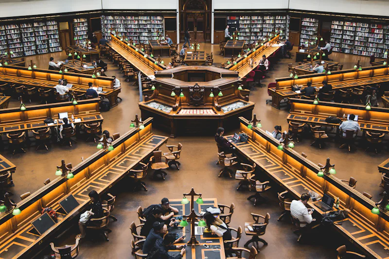 Students reading and working inside a large library